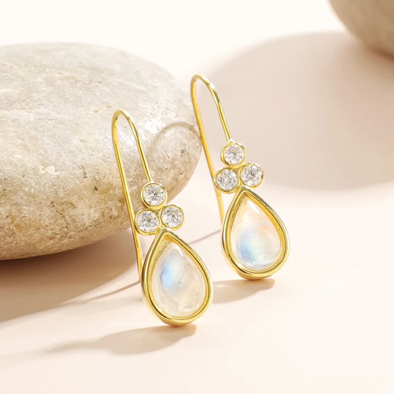Gold moonstone earrings with teardrop moonstones and three clear diamond cz stones