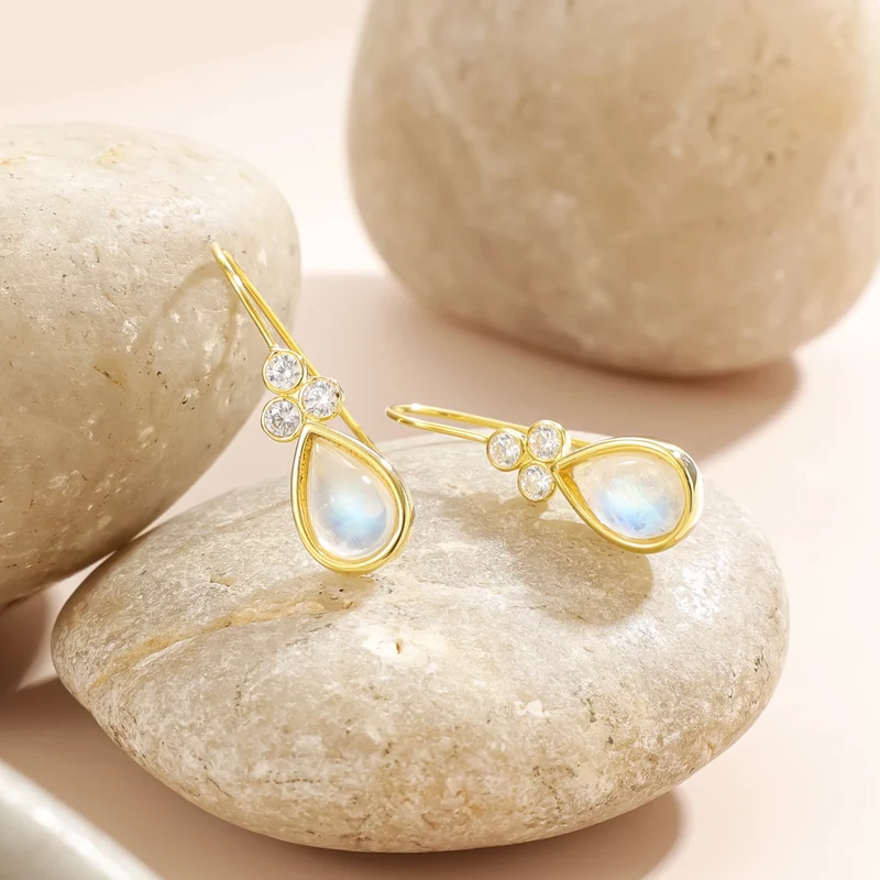 Gold moonstone earrings with teardrop moonstones and three clear diamond cz stones