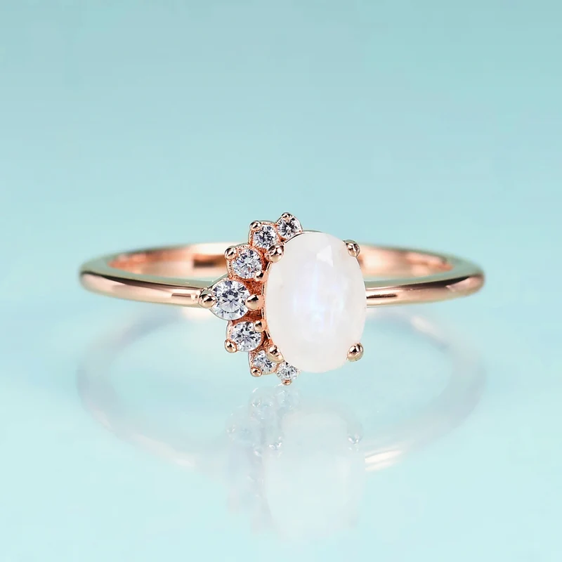 Rose gold moonstone ring with clear cz arranged in a half circle wedding ring for women
